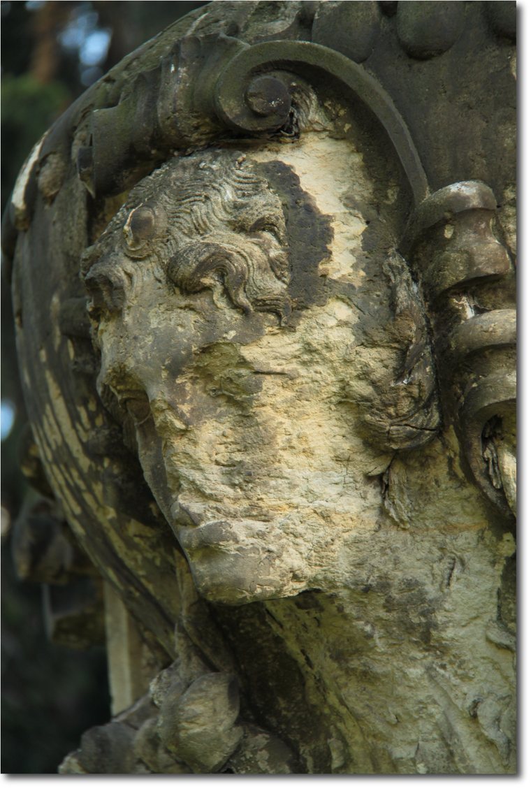 Weathered medieval sandstone sculpture in Dresden with a darkened and eroded surface